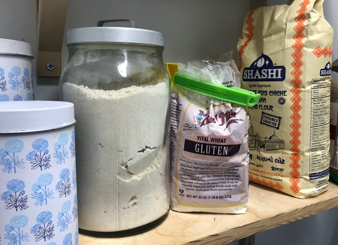 A very obviously labeled bag of chickpea flour next to a canister of another flour.